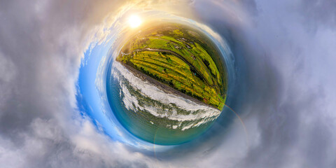 Spherical panoramic aerial shot, sunrise and rainbow, coastline and green pastures © zhang