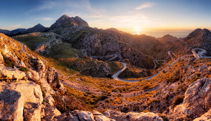 Fototapeta premium Sunset in spanish mountain panorma with road in Sierra de Tramontana Coll dels Reis, island of Mallorca