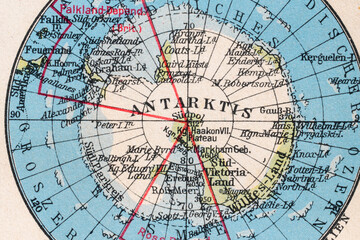 Macro close-up of a vintage map fragment showing Antarctica, islands, coastline details and route lines. Historical cartography background for geography, exploration, travel and archive concepts. © Studio Aurelia
