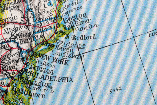 Close-up macro image of a vintage map fragment showing the northeastern United States, including New York, Boston, Philadelphia, Long Island and Cape Cod. Historical cartography background for travel,