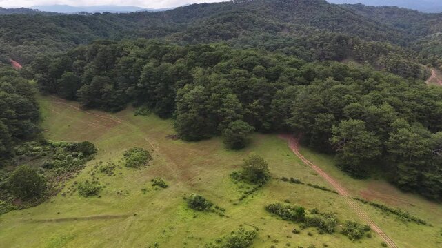 Telephoto drone footage captured near Suoi Vang Lake (Dankia Lake) in Lac Duong District, Lam Dong Province, Vietnam. Filmed with a 3x zoom lens, the drone flies laterally across the landscape, docume