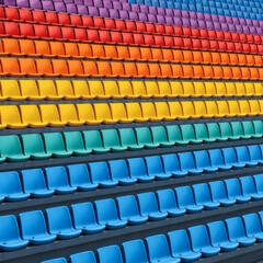 Naklejka premium Rows of colorful stadium seats arranged in a rainbow pattern