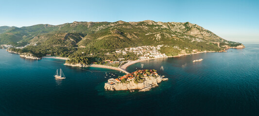 Obraz premium Aerial panorama of Sveti Stefan island resort and Adriatic coastline at sunset in Montenegro