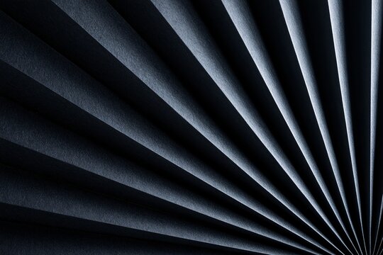Abstract dark blue pleated fabric texture with dramatic light and shadow contrast.