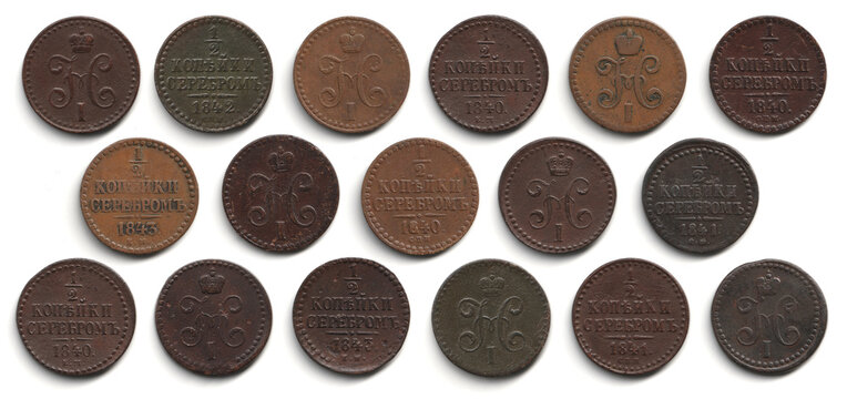 Collection of old brown copper 1/2 kopeck coins 1839-1848 Russian Empire Nicholas I arranged in rows on a white background, showing both sides with worn details, vintage texture.