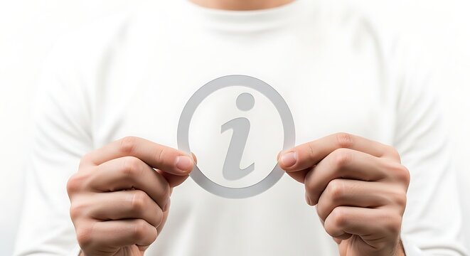 Man pointing at information symbol on shirt.