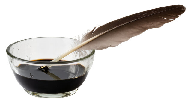 Feather quill dipping into dark ink in glass bowl