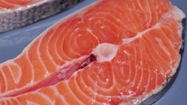 Close-up of raw salmon steak, highlighting fresh texture and natural source of omega-3 fatty acids. . High quality 4k footage