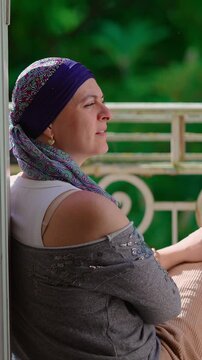 Woman in headscarf speaking with unseen companion during recovery, candid outdoor moment expressing resilience, connection, hope and emotional strength