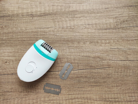 Electric epilator for hair removal and skin care. Device for female hygiene, beauty, depilation and everyday home grooming routine.
