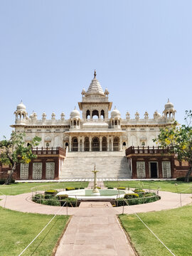 ymmetrical view of Jaswant Thada white marble monument with fountain and garden in Jodhpur, India.