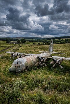 Abandoned Airplane Resting in Open Field Landscape