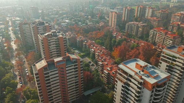 Drone Aerial Establishing of Residential Apartment Buildings and Autumn Trees Near Araucano Park in Las Condes Santiago de Chile