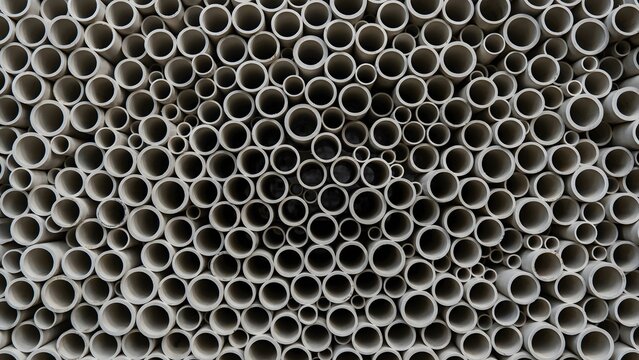 Close-up of numerous gray plastic pipes arranged in a dense pattern