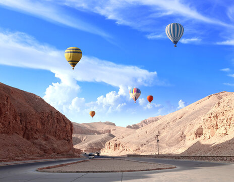 Famous tourist attraction balloon flight in Valley of Kings, Luxor, Egypt. Air balloons over the Theban Necropolis, Luxor, Egypt. Topic of vacation, travel, trip abroad on vacation, cruises and tours