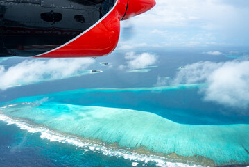 Aerial seaplane view of Maldivian atoll and Trans Maldivian pontoon © Aerial Film Studio