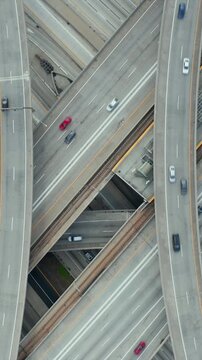 AERIAL: Spectacular Overhead Shot of Judge Pregerson Interchange showing multiple Roads, Bridges, Highway with little car traffic in Los Angeles, California on Beautiful Sunny Day