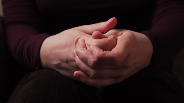 Close-up of nervous hands fidgeting and fingers intertwined during a therapy session with a psychologist. High quality 4k footage