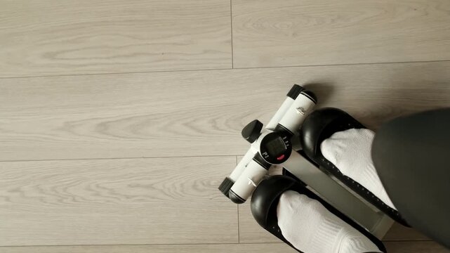 Top-down footage of a person walking on a mini stepper machine during a home cardio session.
Ideal for fitness, exercise, healthy lifestyle, and weight management content.