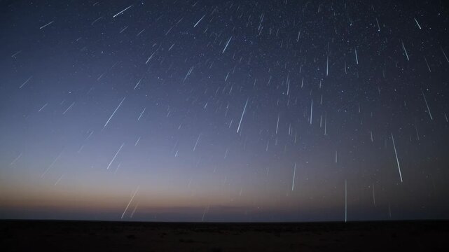 Streaming meteoric streaks racing across night sky over plain, as meteoroids enter atmosphere