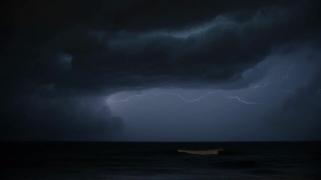 Advancing shelf cloud releasing repeated lightning over shoreline at night, reflecting on wet sand