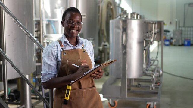 Professional african american female brewmaster working in a brewery