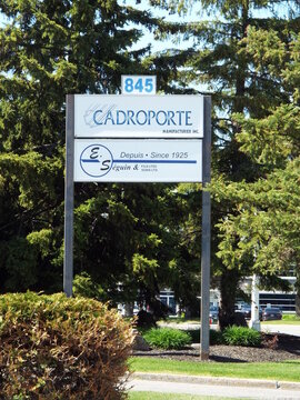 Gatineau,Quebec, Canada &ndash; May 15, 2026: An outdoor standing sign for "Cadroporte Manufacturier Inc. and E. S&eacute;guin & Fils Lt&eacute;e", located 825 Bd de la Carri&egrave;re.