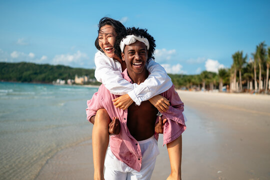 Pure happiness. A young diverse, multiethnic couple enjoys every moment of their tropical getaway