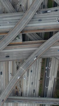 AERIAL: Slow Overhead Flighty Shot of Judge Pregerson Highway showing multiple Roads, Bridges, Viaducts with little car traffic in Los Angeles, California on Beautiful Sunny Day 