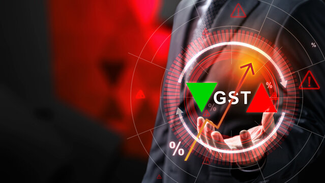 A businessman holding a glowing digital interface showcasing GST tax fluctuations, representing financial analysis, tax regulation, and economic shifts