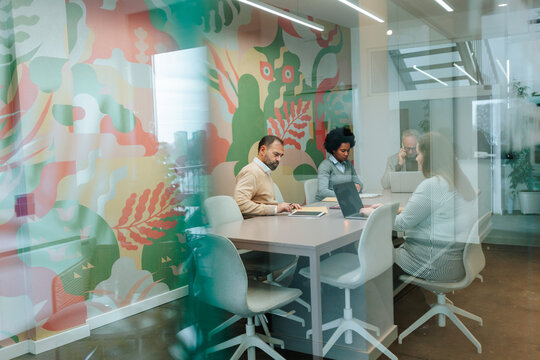 Diverse business professionals collaborating in a modern office meeting