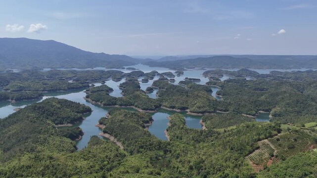 Drone Flying Forward Over Ta Dung Lake and Forested Islands in Dak Nong, Vietnam