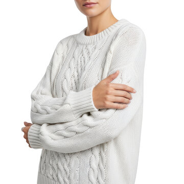 Woman wearing white cable knit sweater.