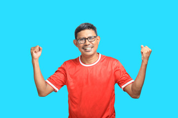 Fototapeta premium Expressive Asian man wearing red t-shirt and glasses gesturing on blue background