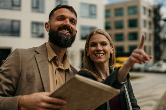 Business people smiling, looking at new property development