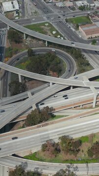 Slowly Circling Aerial View over Judge Pregerson Interchange Highway showing multiple Roads with little car traffic in Los Angeles during times of Coronavirus Covid19 Pandemic on sunny day
