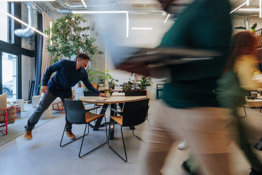 Busy diverse team moving through modern office
