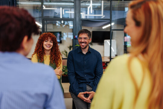 Coworkers smiling at an informal business meeting