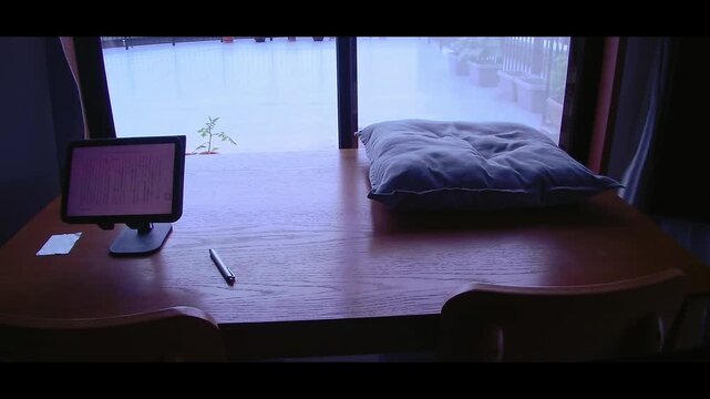 Reading on a tablet in a quiet room with a gentle breeze, peaceful everyday moment with signs of daily life for home lifestyle and relaxation use