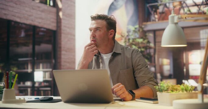 360 Degree. Caucsian Man Works on Laptop in Creative Office, Managing Ecommerce Operations, Analyzing Market Data and Strategizing Digital Innovation for Business Success. Cinematic Arc Tracking Shot.