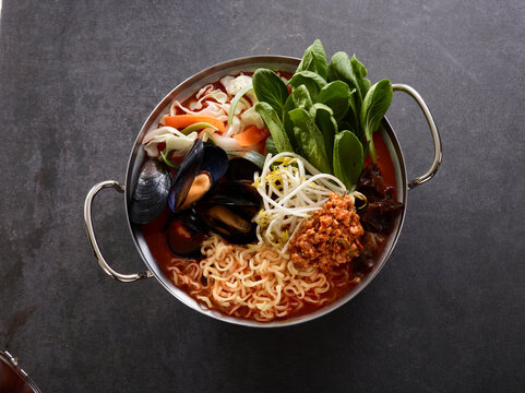 Spicy Korean Seafood Jjamppong Ramen with Minced Meat and Vegetables in Metal Pot