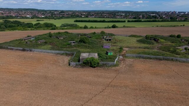 WWII gun emplacements at Chadwell Heath filmed in a forward drone flyover over Whalebone Lane anti-aircraft battery ZE1, concrete bunkers and surrounding Essex fields.