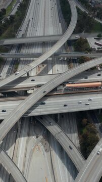 Slowly Circling Aerial View over Judge Pregerson Interchange Highway showing multiple Roads with little car traffic in Los Angeles during times of Coronavirus Covid19 Pandemic on sunny day
