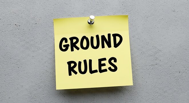 Set of ground rules written on a yellow sticky note pinned to a wall