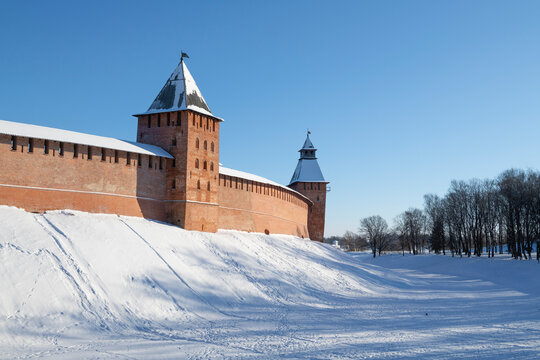 Ancient fortress wall with towers of the Novgorod detinets on a sunny February day. Veliky Novgorod, Russia