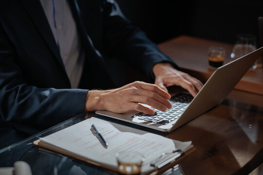 Business professional hands typing on laptop at office desk