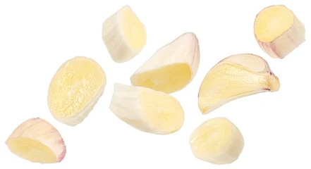 Falling garlic clove slices isolated on white background © xamtiw