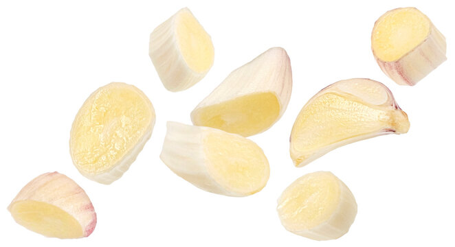 Falling garlic clove slices isolated on white background