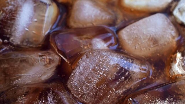 Macro Close Up of cola bubbles and ice cubes background