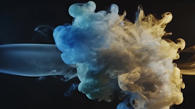 A captivating abstract image showcases swirling blue and yellow ink clouds suspended in a dark, atmospheric setting, creating a mesmerizing visual effect.
